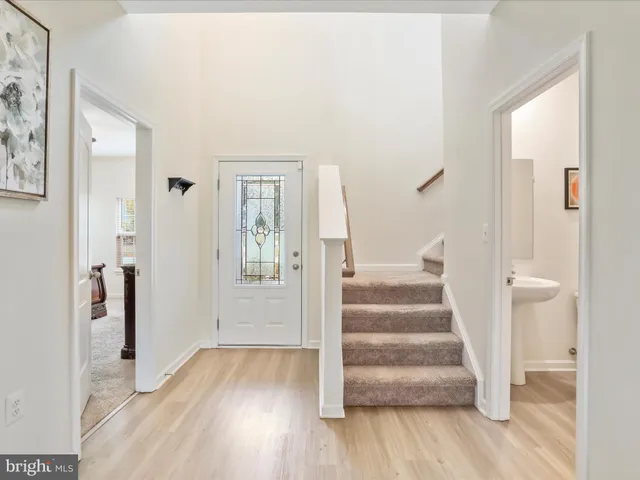 a view of an entryway with wooden floor and door