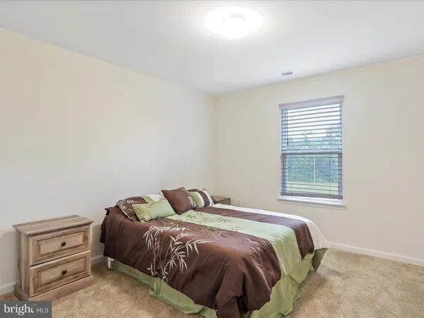 a bedroom with a bed and a mirror