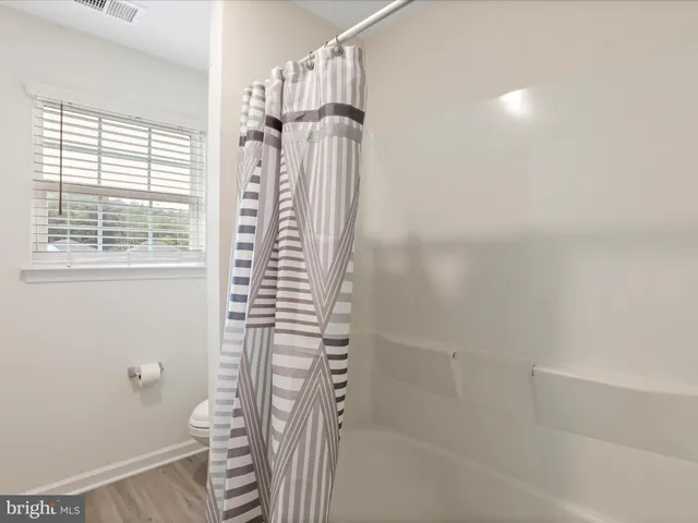 a bedroom with bed and window