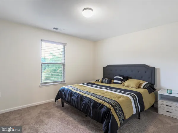 a bedroom with a bed and flat screen tv