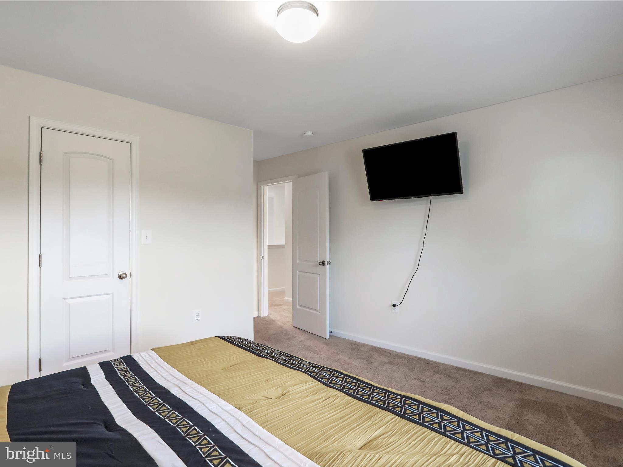 208 Rappahannock Run Falling Waters, WV 25419 - Photo 26 of 44 a bedroom with a bed and flat screen tv