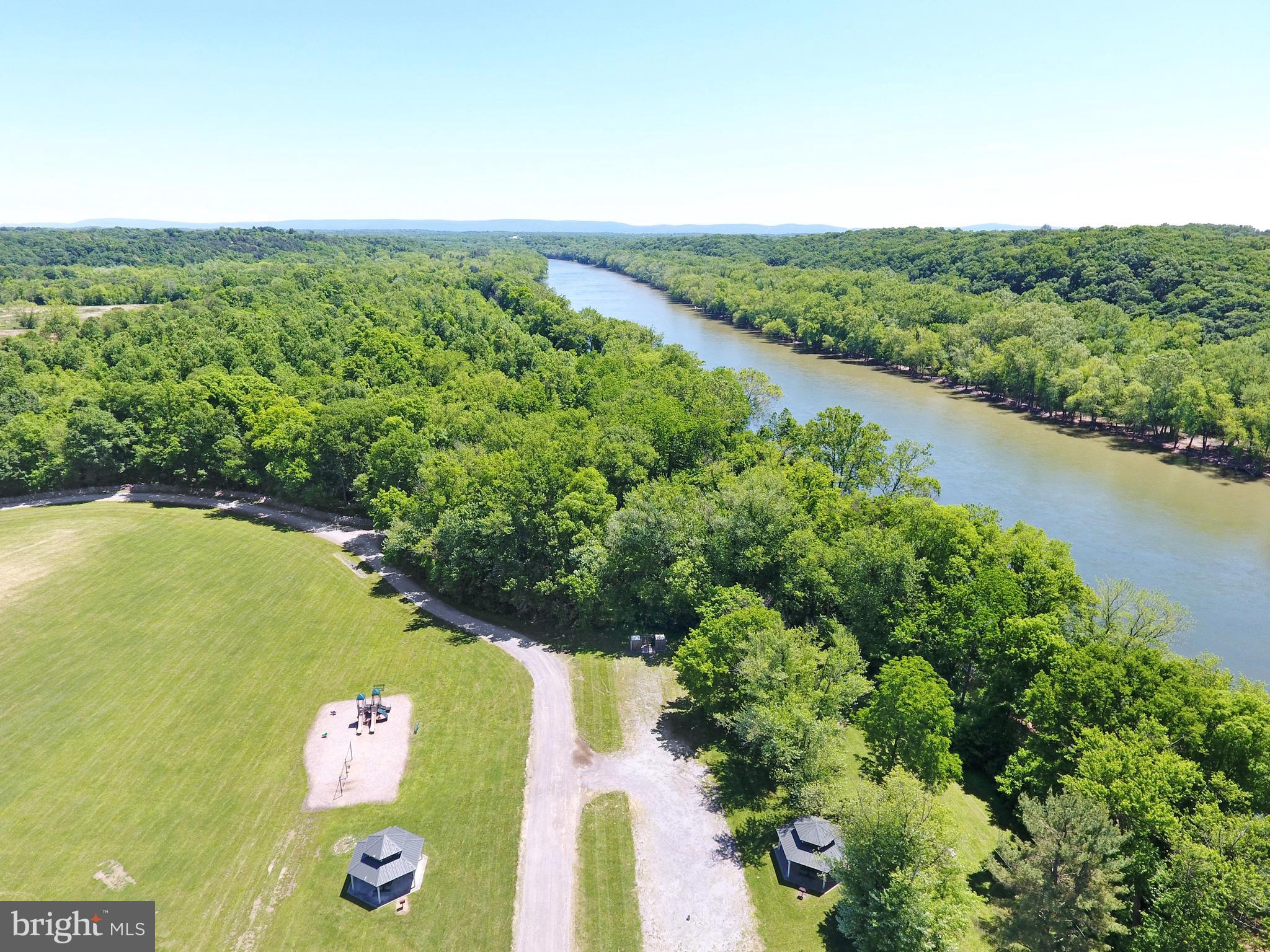 208 Rappahannock Run Falling Waters, WV 25419 - Photo 39 of 44 a view of a lake with a yard