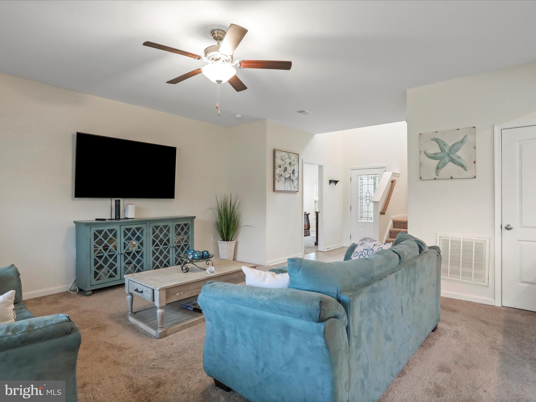 208 Rappahannock Run Falling Waters, WV 25419 - Photo 4 of 44 a living room with furniture and a flat screen tv