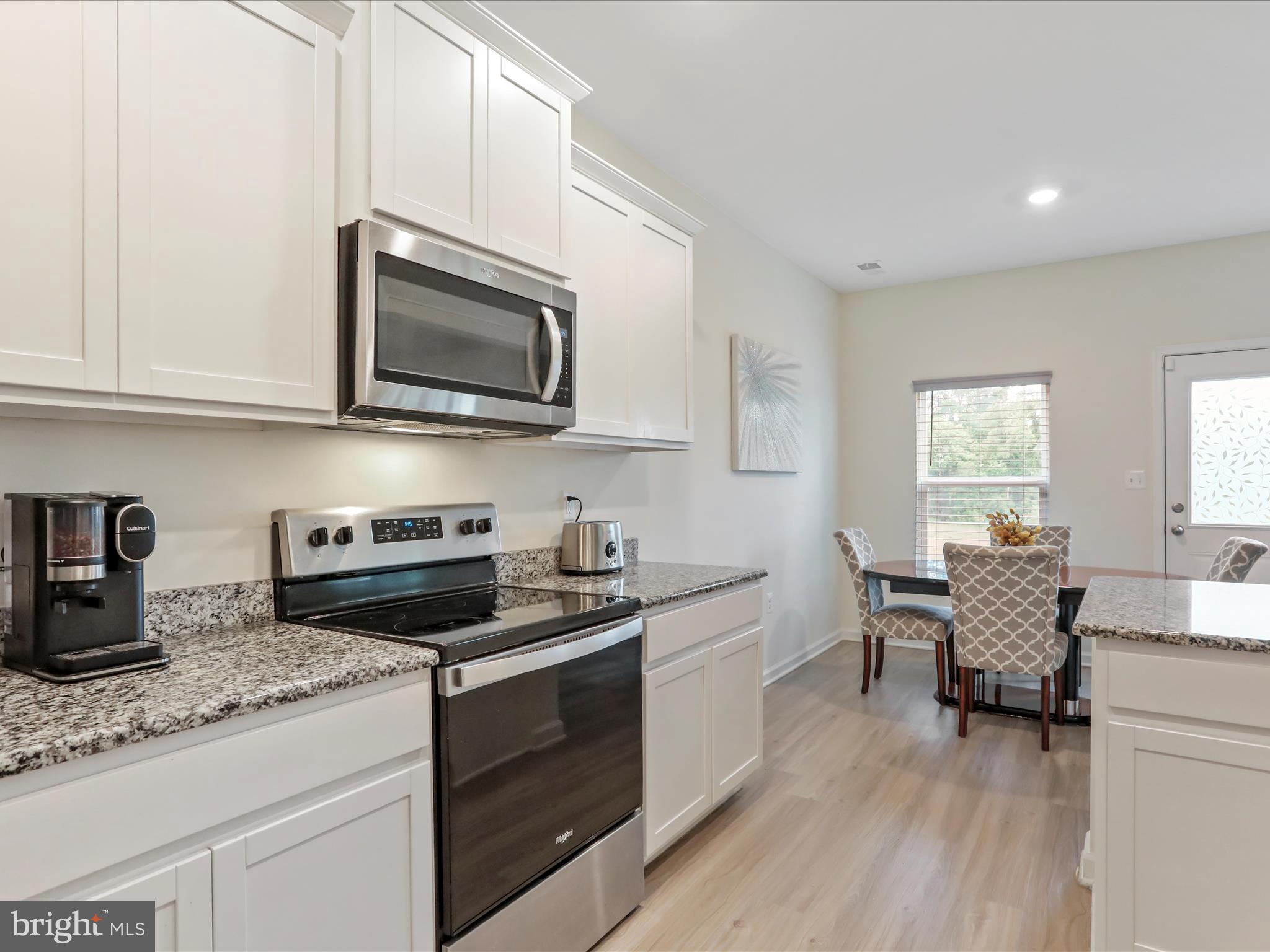 208 Rappahannock Run Falling Waters, WV 25419 - Photo 7 of 44 a kitchen with granite countertop a sink cabinets stainless steel appliances and a window