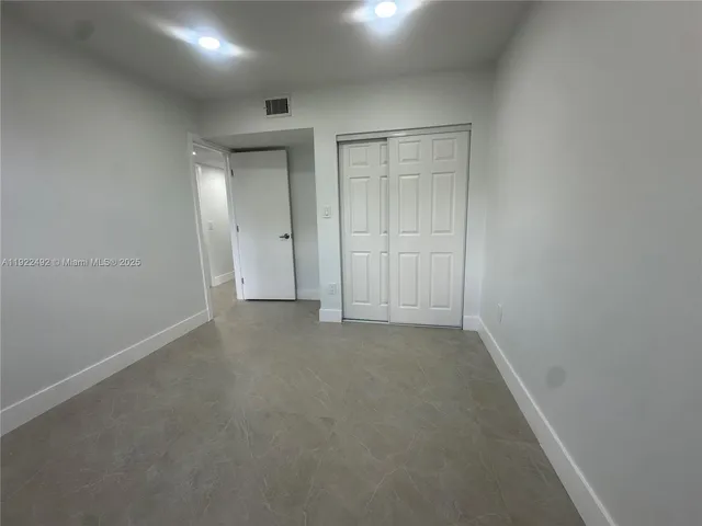 an empty room with closet area