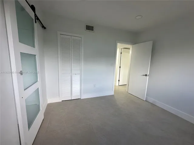 an empty room with a fireplace and a vanity