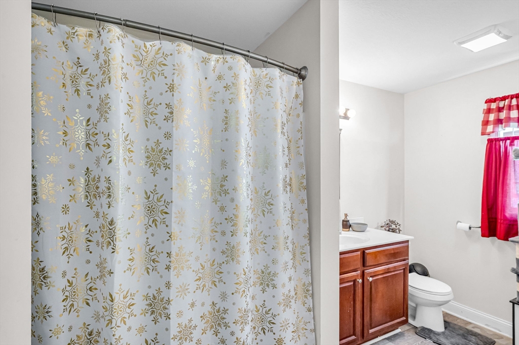 31 Acrebrook Road Springfield, MA 01129 - Photo 21 of 42 a bathroom with a shower curtain and a toilet
