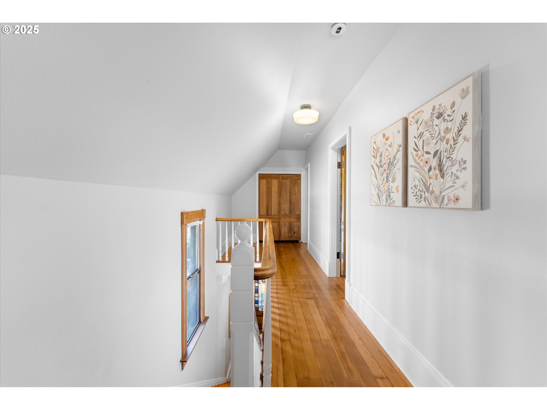 3635 South Corbett Avenue Portland, OR 97239 - Photo 18 of 30 a open hall with stairs and a wooden floor