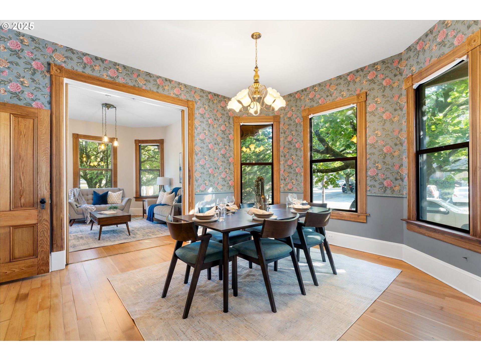 3635 South Corbett Avenue Portland, OR 97239 - Photo 2 of 30 a dining room with furniture a chandelier and wooden floor