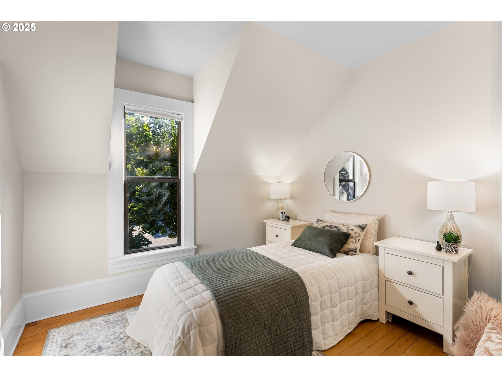 3635 South Corbett Avenue Portland, OR 97239 - Photo 3 of 30 a bedroom with a bed and a window