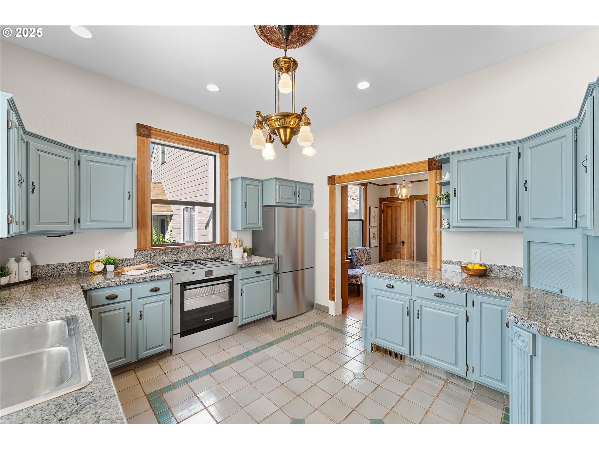 3635 South Corbett Avenue Portland, OR 97239 - Photo 6 of 30 a large kitchen with kitchen island a sink stainless steel appliances and cabinets
