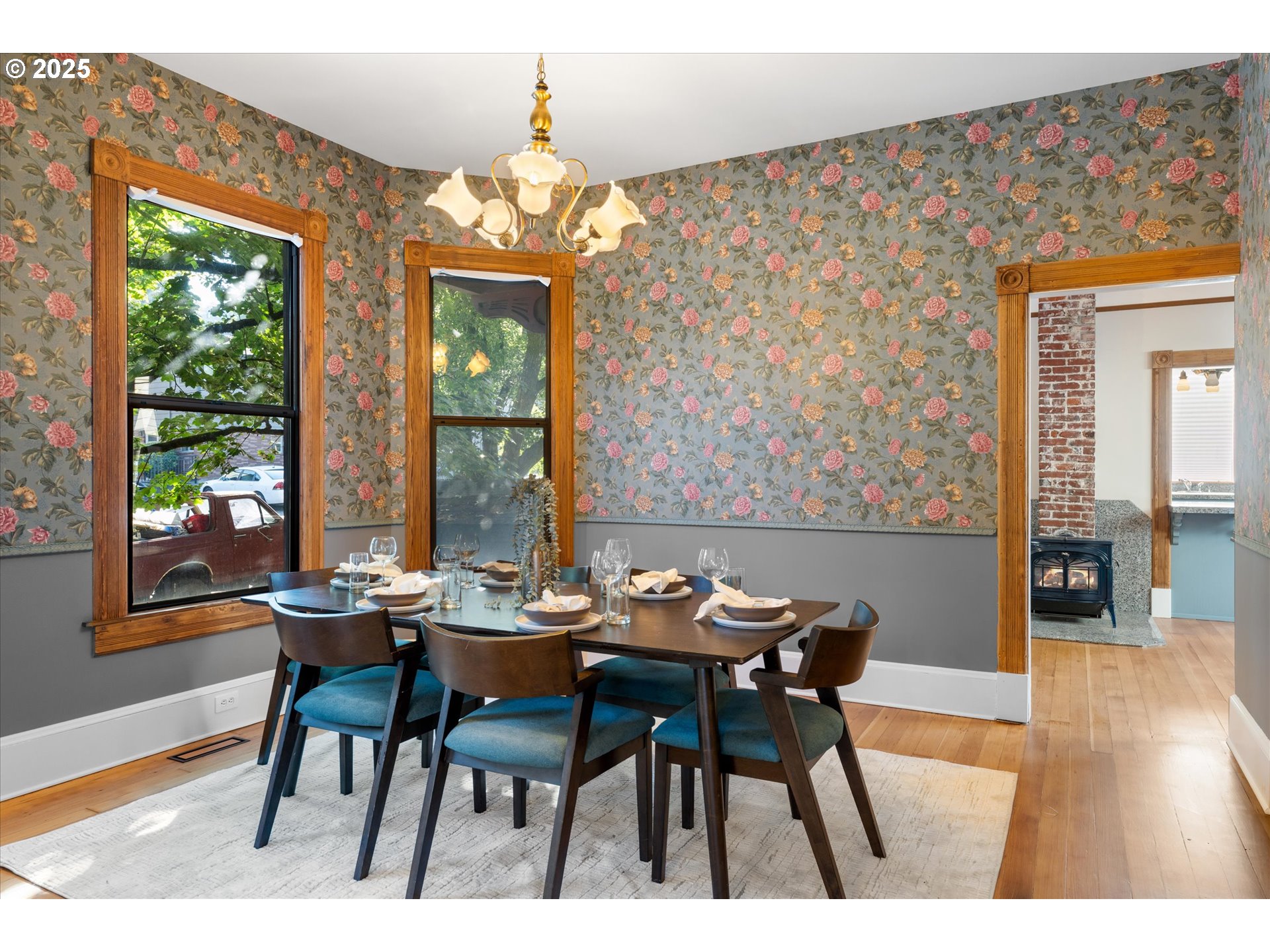 3635 South Corbett Avenue Portland, OR 97239 - Photo 9 of 30 a dining room with furniture a chandelier and wooden floor