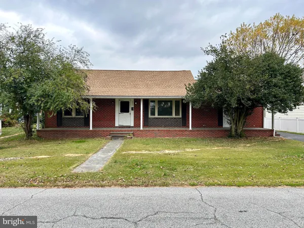 a view of a house with a swimming pool and a large tree