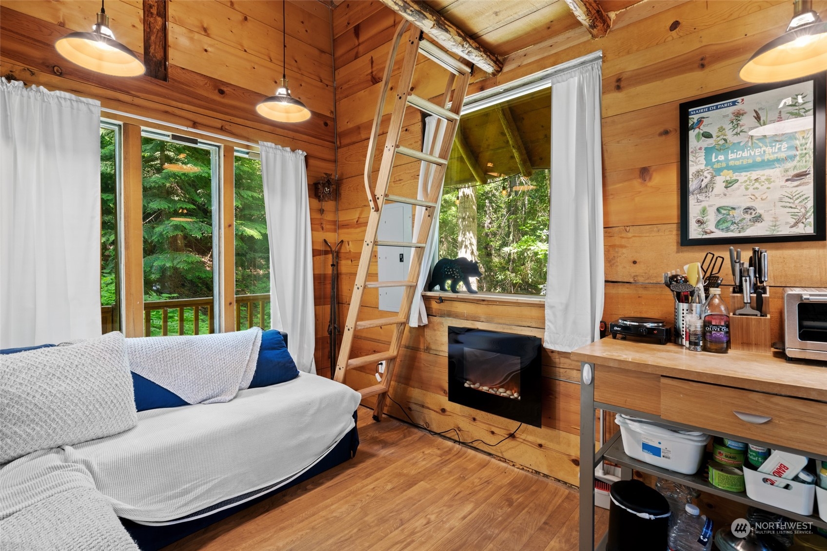15869 Cedar Brae Road Leavenworth, WA 98826 - Photo 5 of 19 a living room with furniture a fireplace and a floor to ceiling window