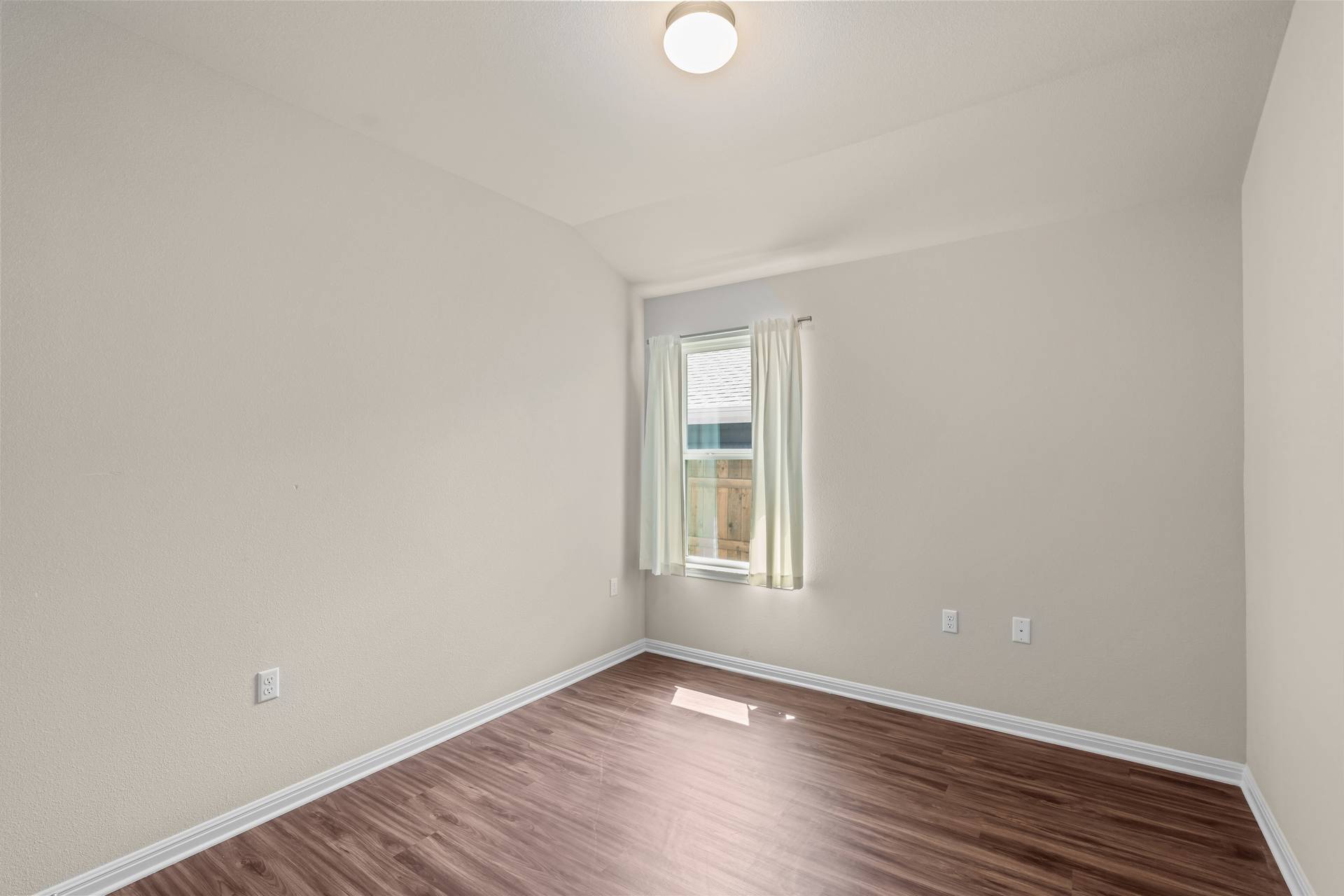 16512 Enamorado Road Manor, TX 78653 - Photo 4 of 31 Rich hardwood floors create a warm, inviting atmosphere in this sun-filled space.