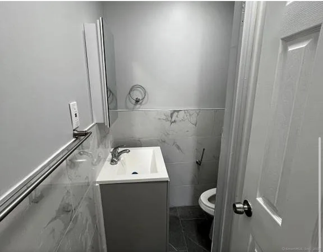 639 Barnum Avenue, Unit 1R Bridgeport, CT 06608 - Photo 3 of 3 a bathroom with a toilet and a sink