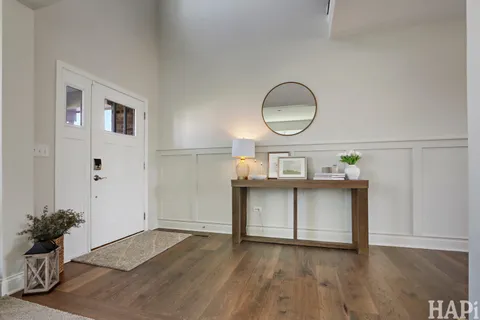 a living room with furniture and a dining table with wooden floor