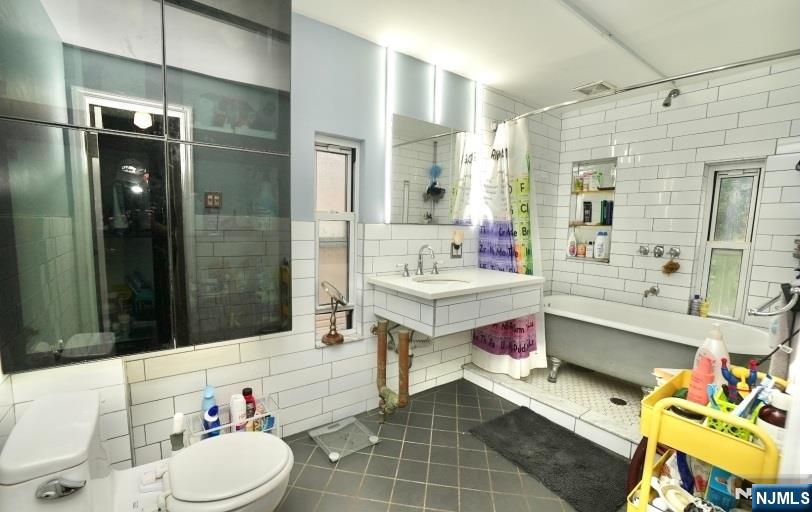 13 Thomas Street Bloomfield, NJ 07003 - Photo 11 of 18 a bathroom with a sink mirror vanity and toilet