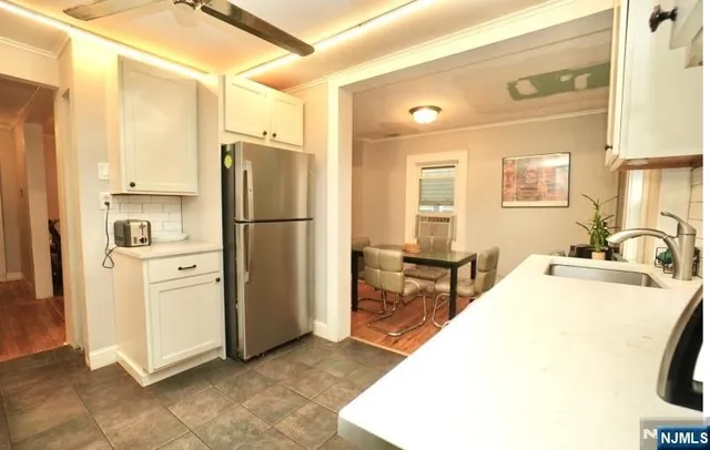 a kitchen with stainless steel appliances a refrigerator and a stove