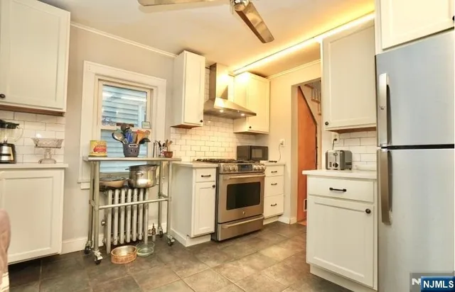 a kitchen with a refrigerator sink and cabinets