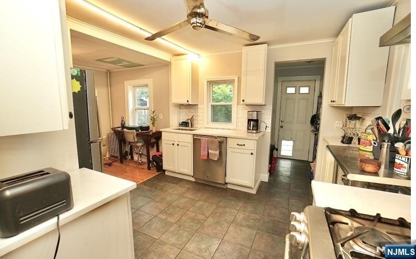 13 Thomas Street Bloomfield, NJ 07003 - Photo 4 of 18 a large white kitchen with a large window