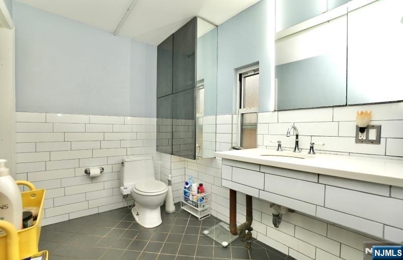 13 Thomas Street Bloomfield, NJ 07003 - Photo 10 of 18 a bathroom with a sink toilet mirror and vanity