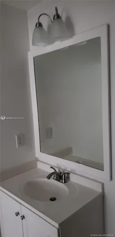 a bathroom with a sink and mirror