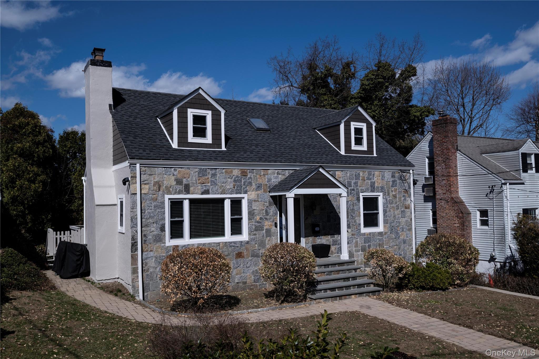 a front view of a house with a garden