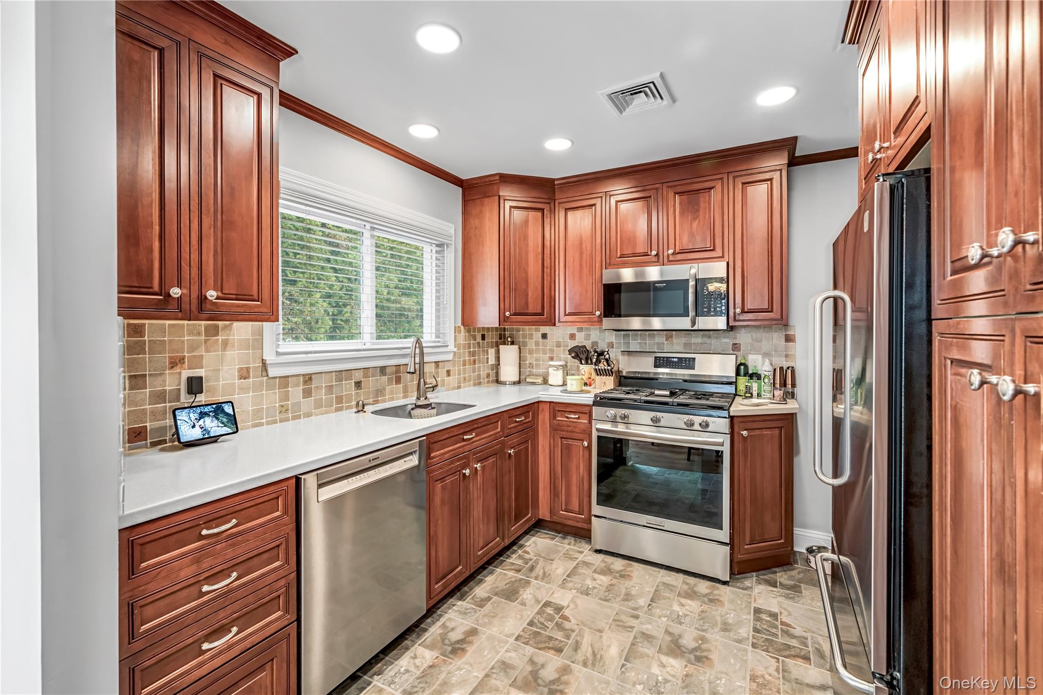 40 Wickford Road New Rochelle, NY 10801 - Photo 11 of 32 a kitchen with stainless steel appliances granite countertop a sink a stove a refrigerator cabinets and a window
