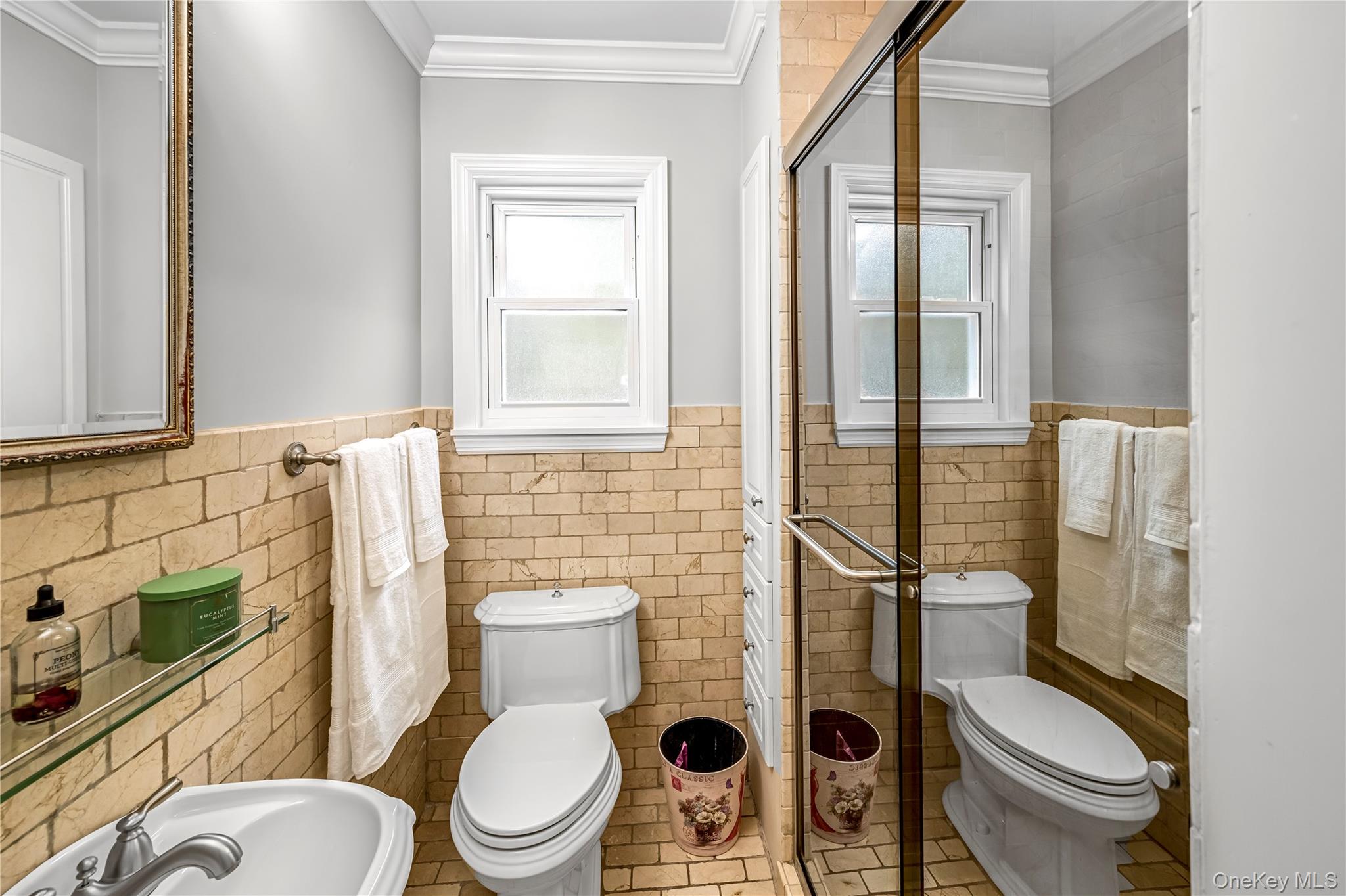 40 Wickford Road New Rochelle, NY 10801 - Photo 15 of 32 a white toilet sitting next to a bathroom sink and a shower
