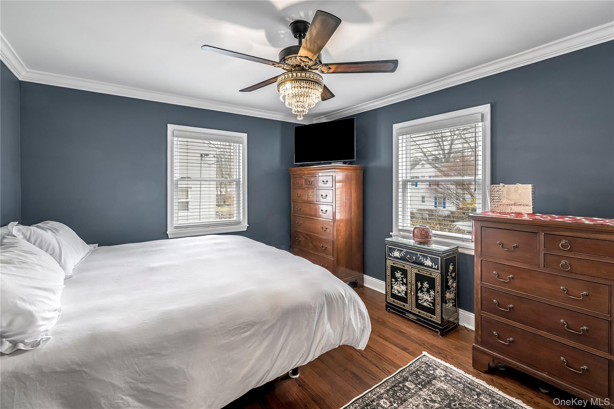 40 Wickford Road New Rochelle, NY 10801 - Photo 18 of 32 a bedroom with a bed and a chandelier