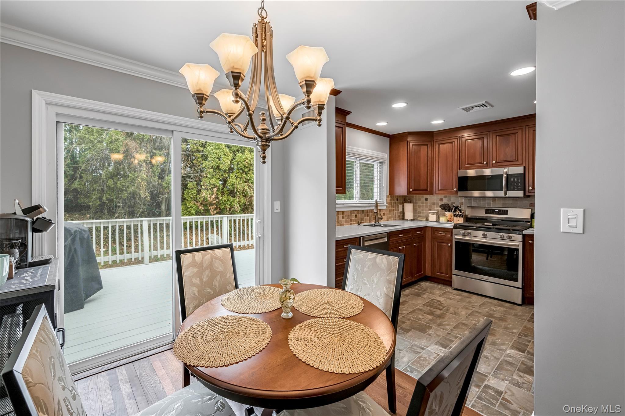40 Wickford Road New Rochelle, NY 10801 - Photo 8 of 32 a kitchen with a table chairs a stove and a chandelier