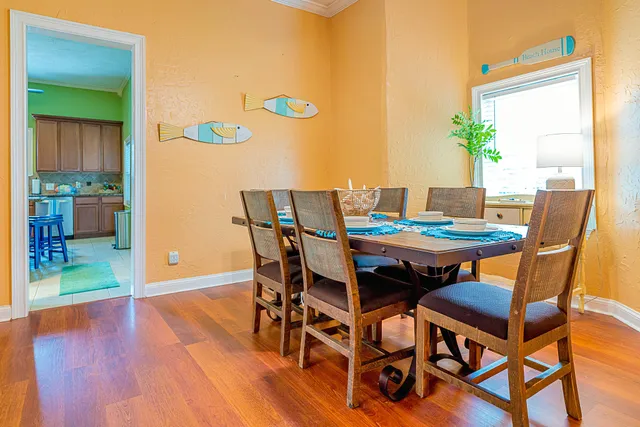 a dining room with furniture and wooden floor