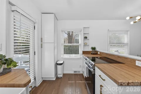 a kitchen that has a sink a stove and a window