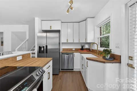 a kitchen with a sink stove and refrigerator