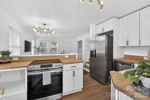 a kitchen with stainless steel appliances granite countertop a stove a refrigerator and a stove