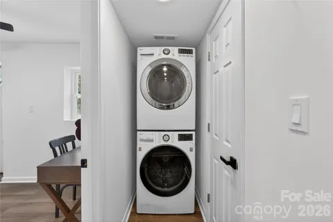 a utility room with dryer washer and a view of bathroom