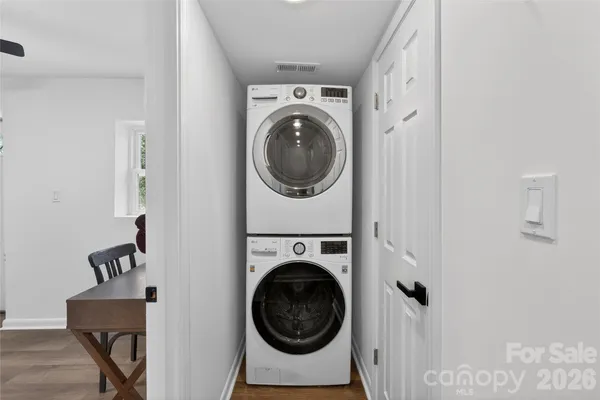 a utility room with dryer washer and a view of bathroom
