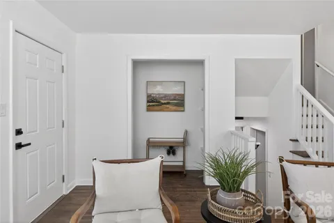 a living room with furniture a potted plant and a fireplace