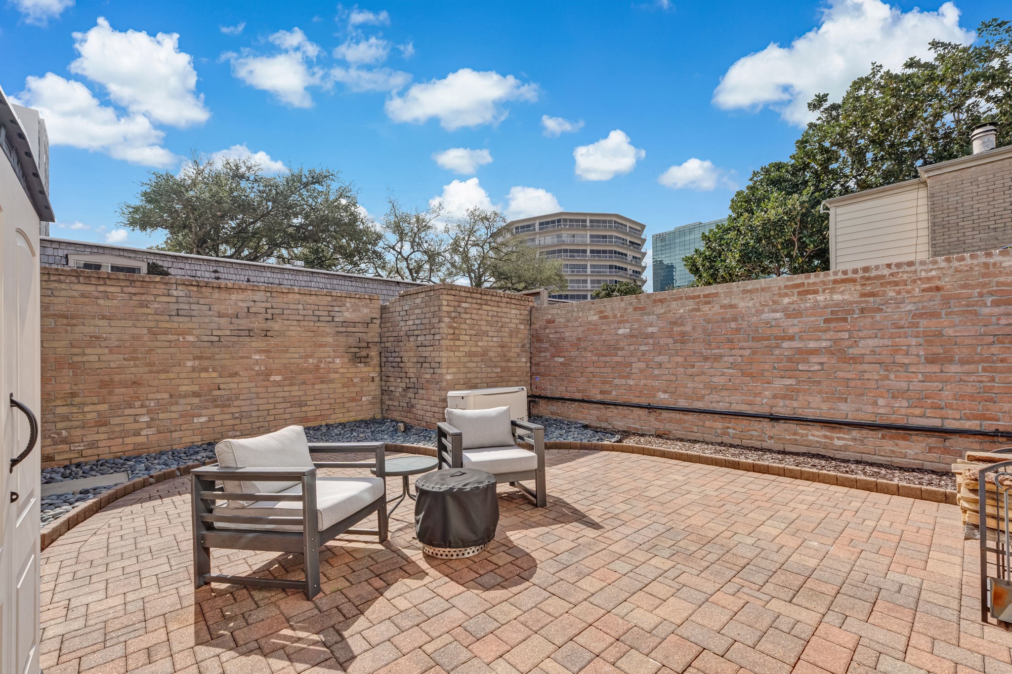 516 South Post Oak Lane, Unit 18 Houston, TX 77056 - Photo 19 of 20 Alternate patio view, displaying Generac whole-home generator for added reliability.