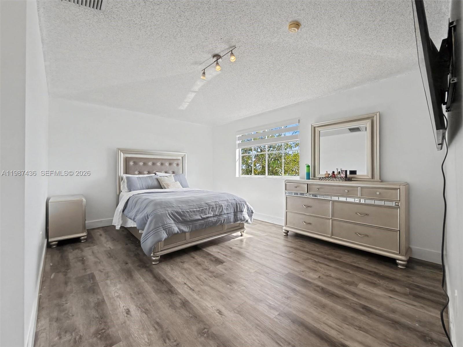 16004 Southwest 87th Terrace Miami, FL 33193 - Photo 12 of 30 a bedroom with a bed and a couch