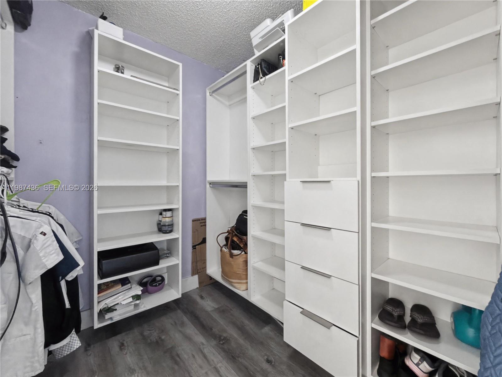 16004 Southwest 87th Terrace Miami, FL 33193 - Photo 14 of 30 a view of walk in closet with empty racks