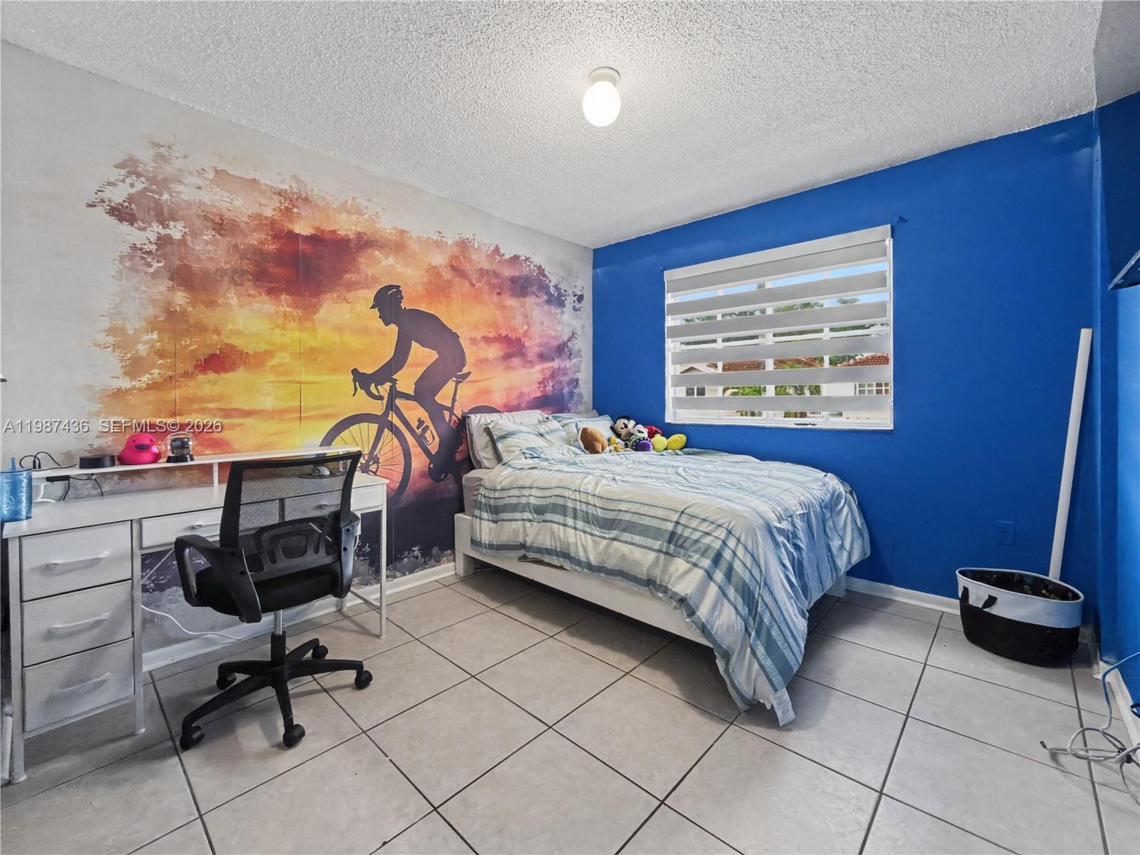16004 Southwest 87th Terrace Miami, FL 33193 - Photo 23 of 30 a bedroom with a bed a desk and chair