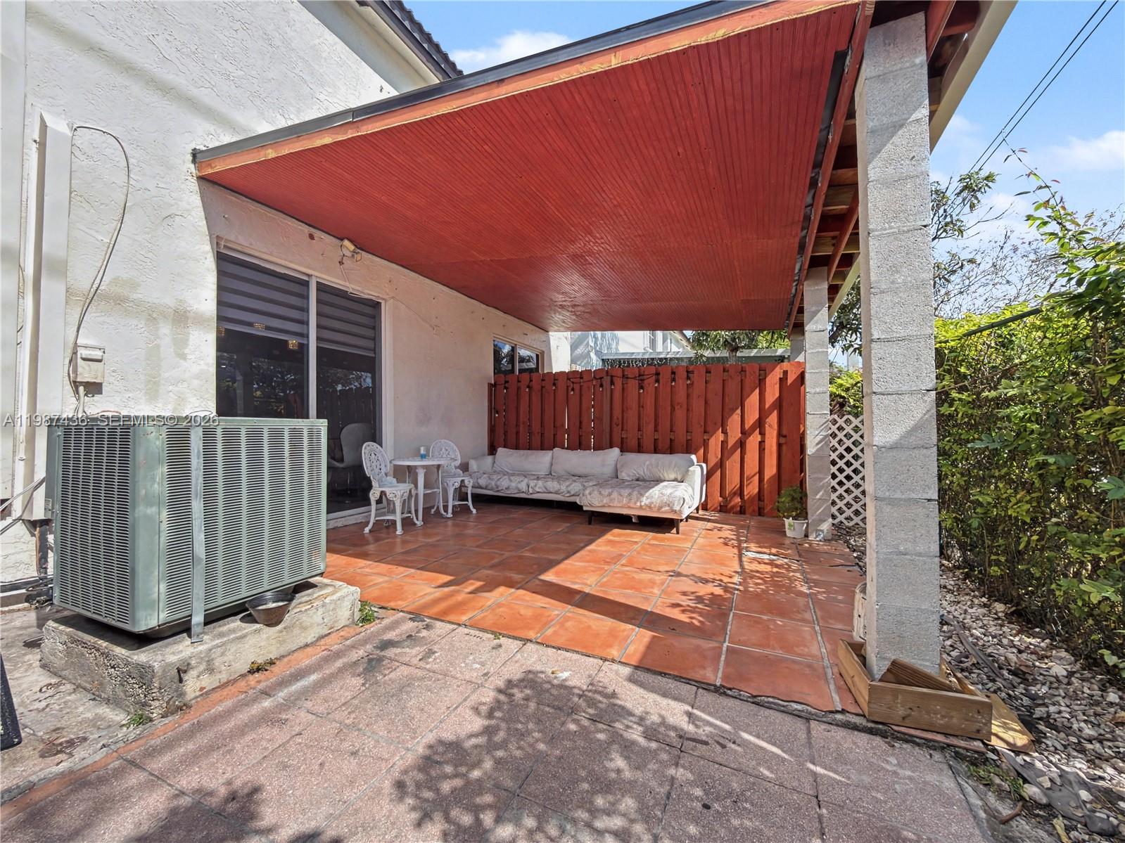 16004 Southwest 87th Terrace Miami, FL 33193 - Photo 27 of 30 a view of a backyard with a small cabin and wooden chair