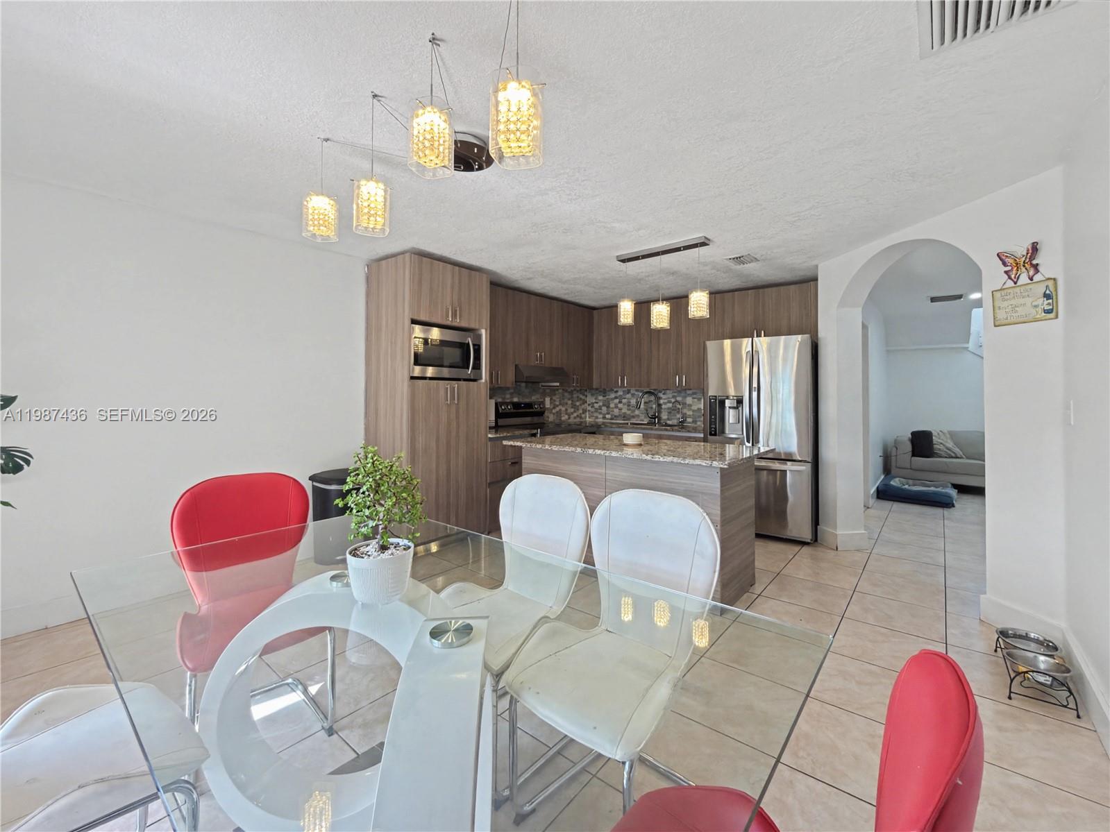 16004 Southwest 87th Terrace Miami, FL 33193 - Photo 3 of 30 a living room with furniture a dining table and kitchen view