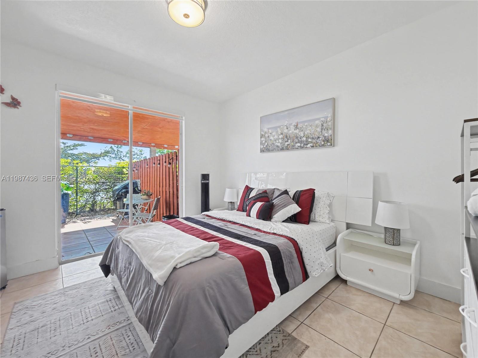 16004 Southwest 87th Terrace Miami, FL 33193 - Photo 5 of 30 a bedroom with a bed and a large window