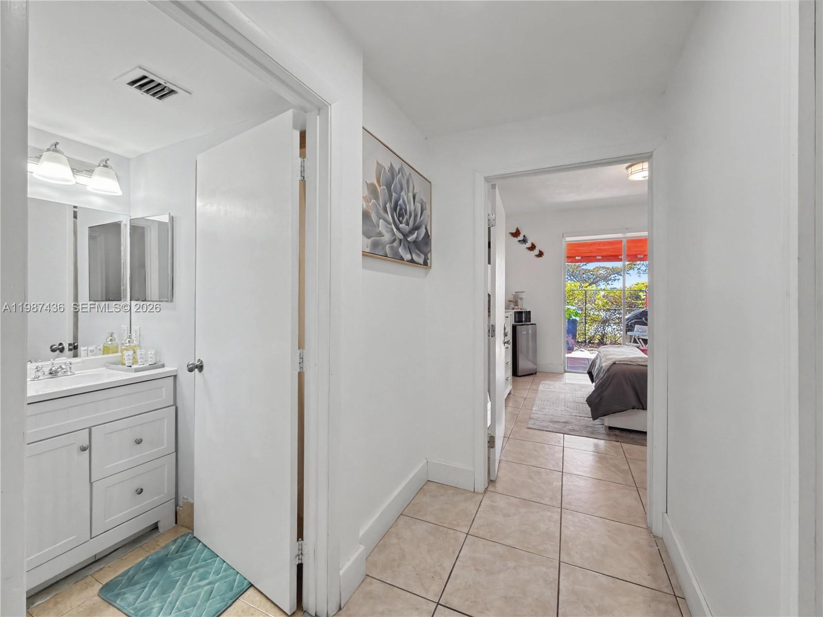 16004 Southwest 87th Terrace Miami, FL 33193 - Photo 8 of 30 a view of hallway with livingroom and painting on the wall