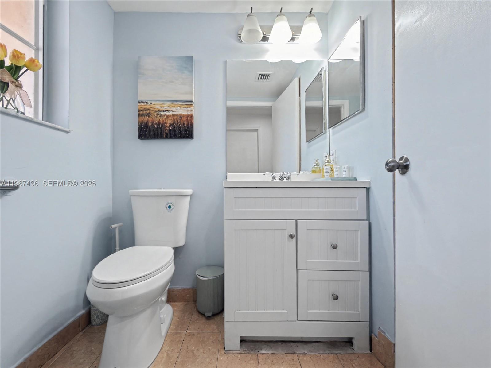 16004 Southwest 87th Terrace Miami, FL 33193 - Photo 9 of 30 a bathroom with a toilet a sink and mirror