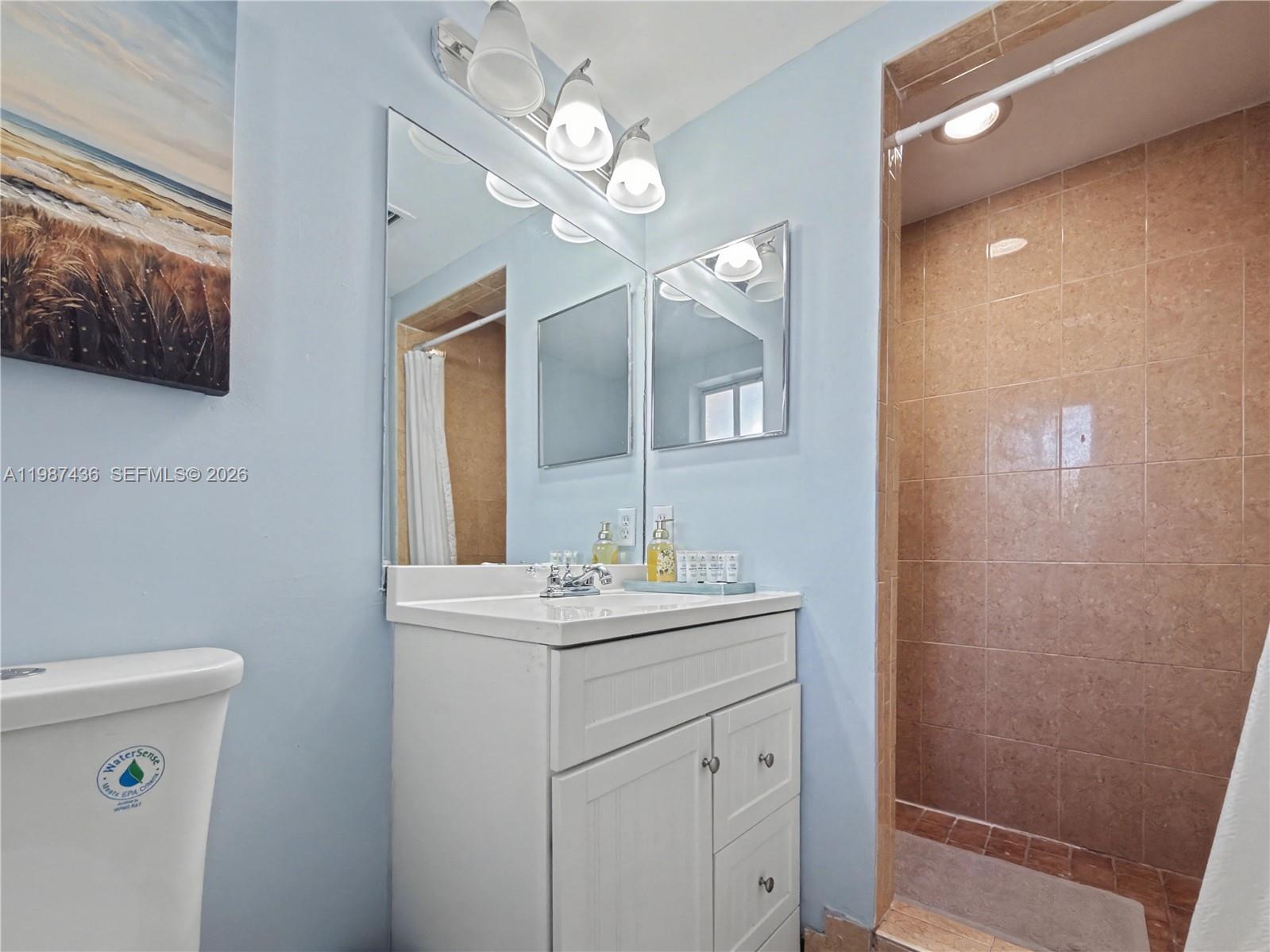 16004 Southwest 87th Terrace Miami, FL 33193 - Photo 10 of 30 a bathroom with a sink a light fixture and a toilet