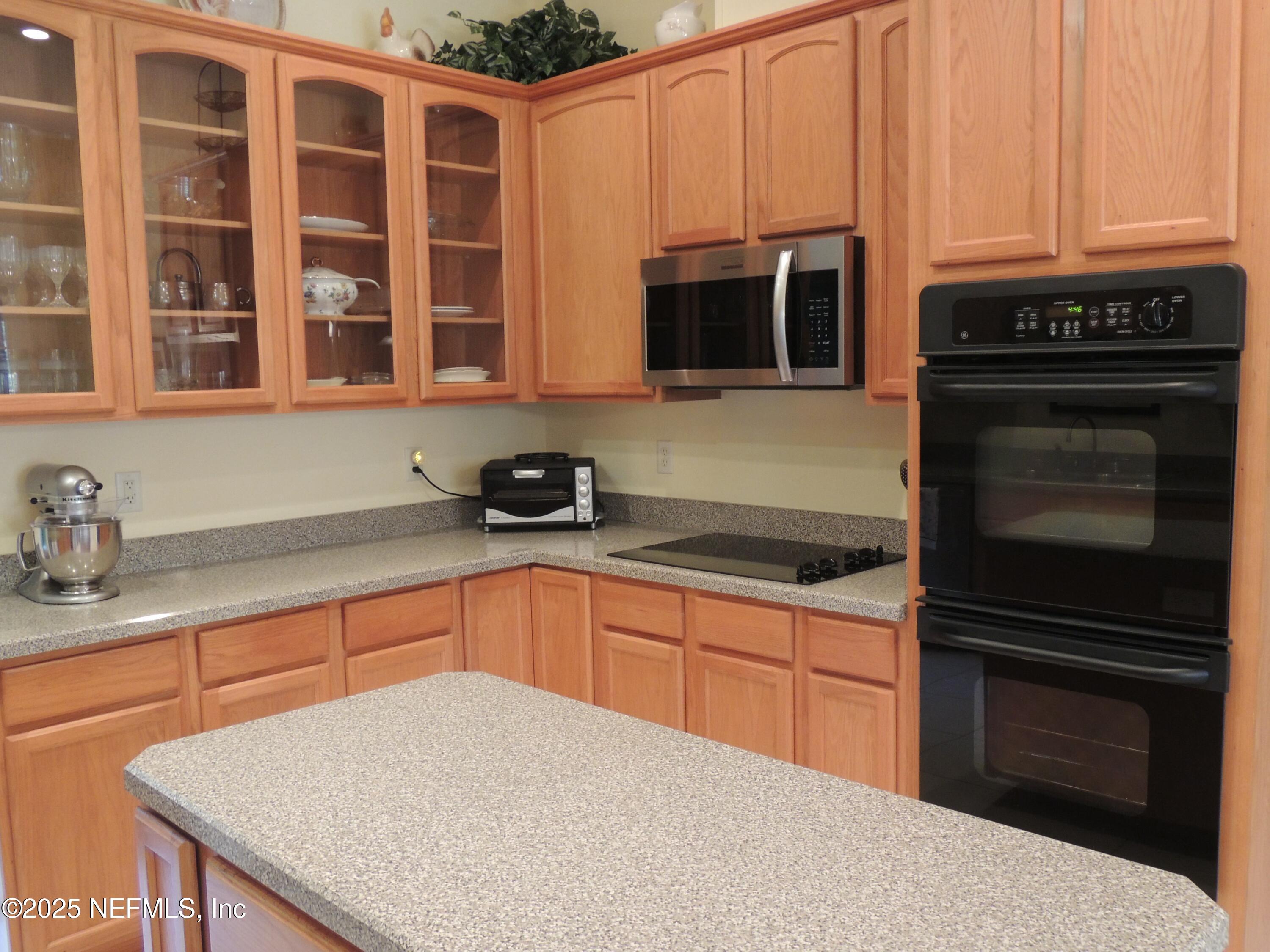 9058 Butcher Road Glen St. Mary, FL 32040 - Photo 16 of 43 a kitchen with stainless steel appliances granite countertop a stove microwave and sink
